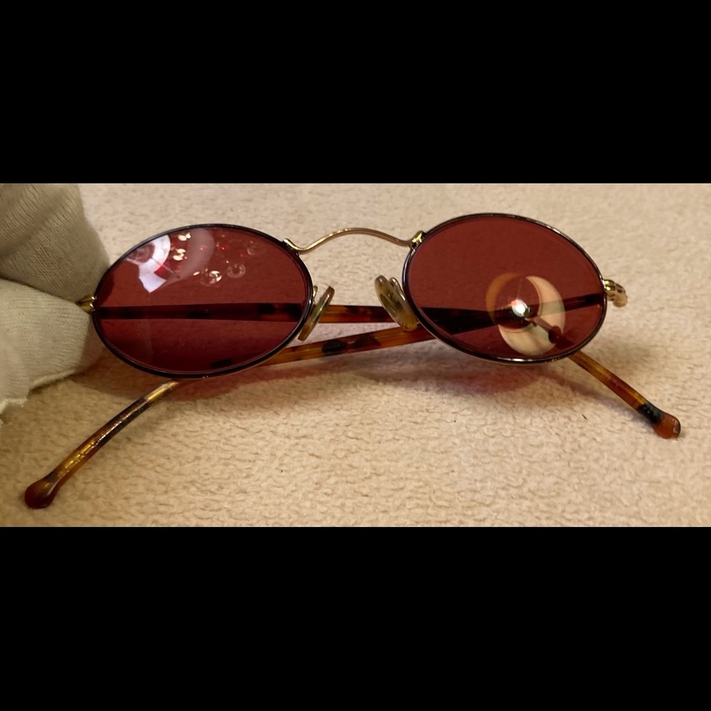 Vintage pair of oval sunglasses,tortoise earpieces,gold metal frame,amber lenses